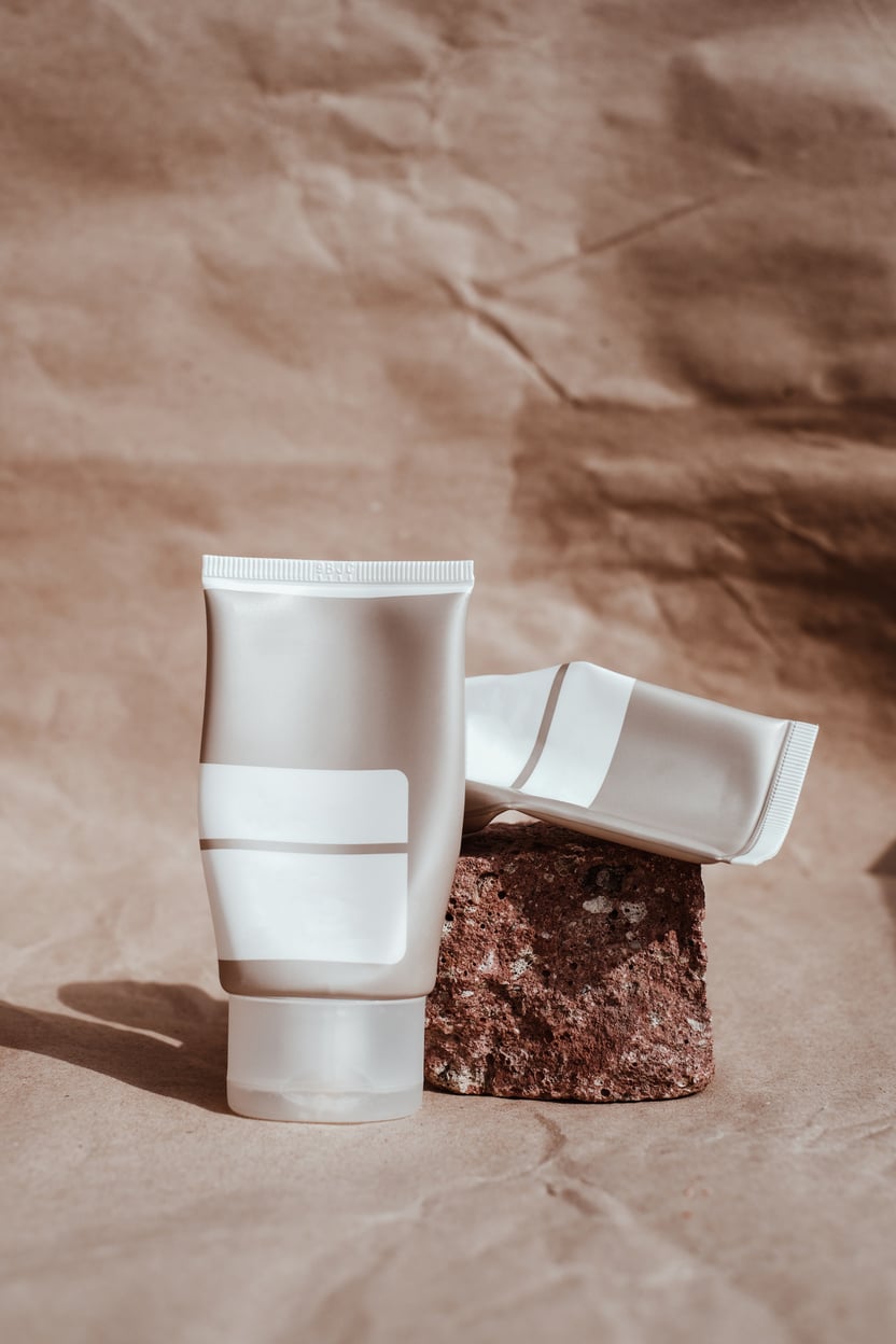 Minimalist Packaging of Cosmetic Products on Brown Background